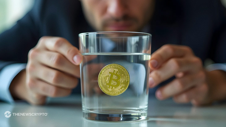 Close-up of a person holding a physical Bitcoin, symbolizing analysis and uncertainty in the crypto market cycle.