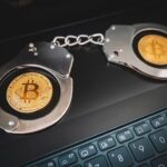NYPD officers escort a handcuffed man from a precinct in Manhattan, tied to a disturbing Bitcoin extortion and torture investigation.