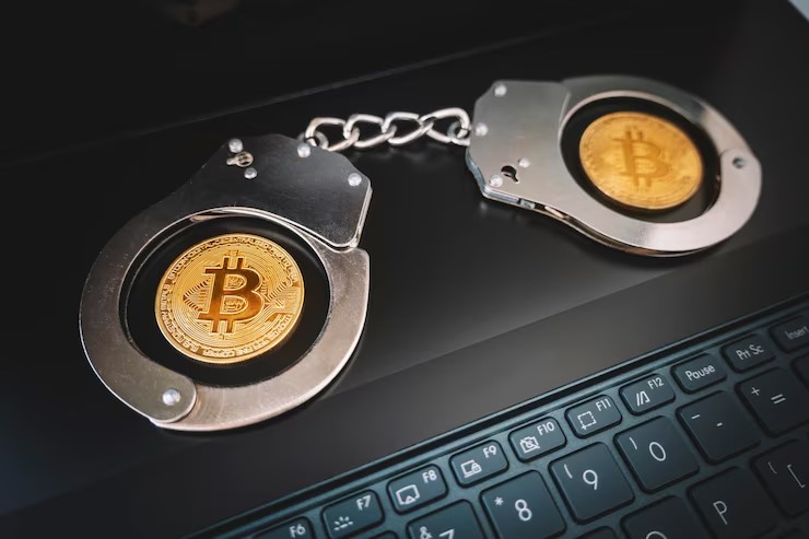 NYPD officers escort a handcuffed man from a precinct in Manhattan, tied to a disturbing Bitcoin extortion and torture investigation.